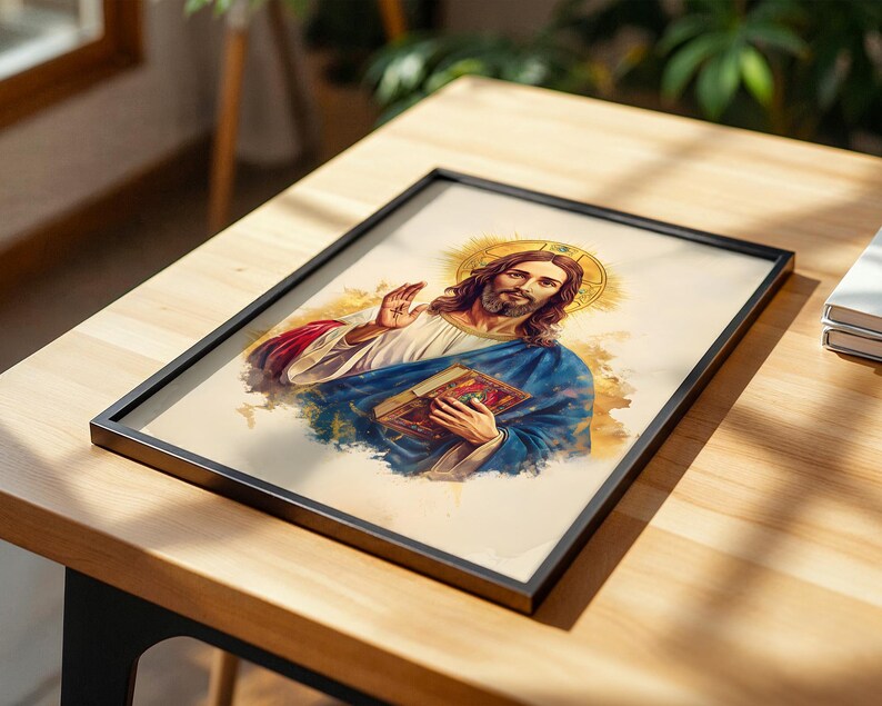 May include: A framed print featuring a watercolor-style illustration of a figure with long brown hair and a beard, wearing a white robe and blue cloak, holding a book in one hand and raising the other, set against a golden halo background.