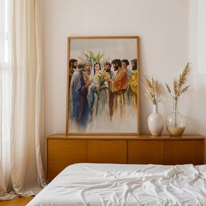 May include: A framed vertical wall art print depicting a watercolor scene of a central female figure in a white veil holding yellow lilies, surrounded by a group of men in robes. The artwork features soft brushstrokes and muted earth tones.
