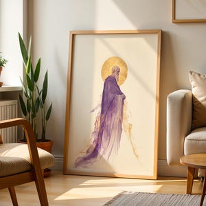 May include: A framed vertical art print featuring a side profile of a bearded figure with a golden halo, wearing a flowing purple robe that dissolves into abstract wisps at the bottom. The artwork is set against a light cream background.