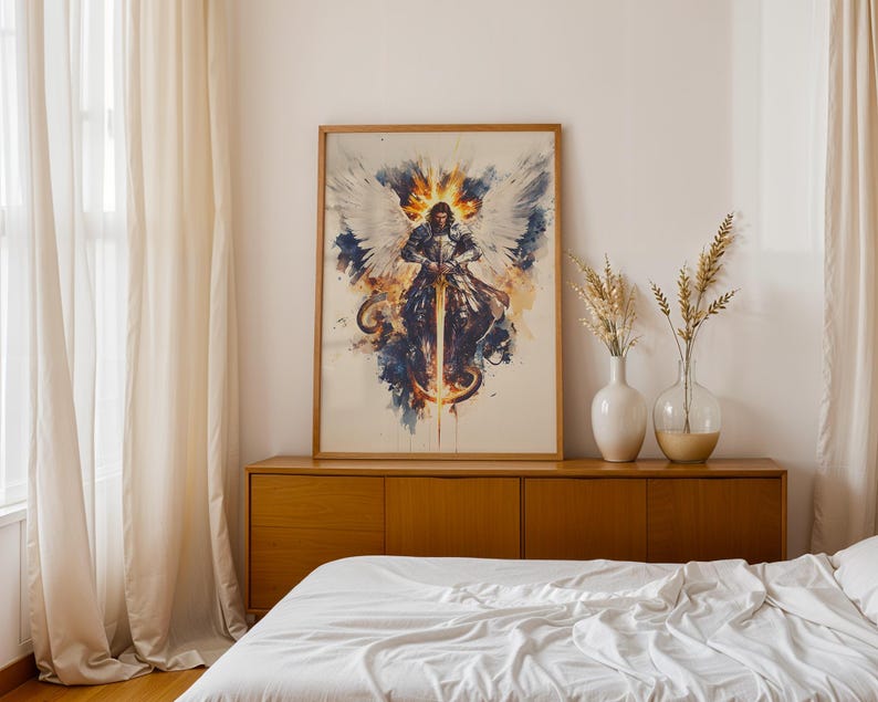 May include: A framed wall art print featuring a watercolour-style illustration of a winged warrior in silver armour holding a glowing sword. The artwork displays a central figure with large white wings, surrounded by splashes of blue, gold, and orange.