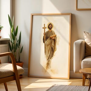 Peut inclure: Une impression d'art mural encadr&eacute;e repr&eacute;sentant une illustration &agrave; l'aquarelle d'un personnage barbu avec une aur&eacute;ole, portant des robes drap&eacute;es, tenant une croix en bois dans une main et un pain dans l'autre, sur un fond cr&egrave;me clair.