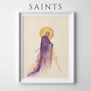 May include: A framed art print titled SAINTS featuring a bearded figure in a flowing purple robe with a golden halo behind the head. The figure is depicted in a watercolour style with ethereal, wispy edges fading into a cream-coloured background.
