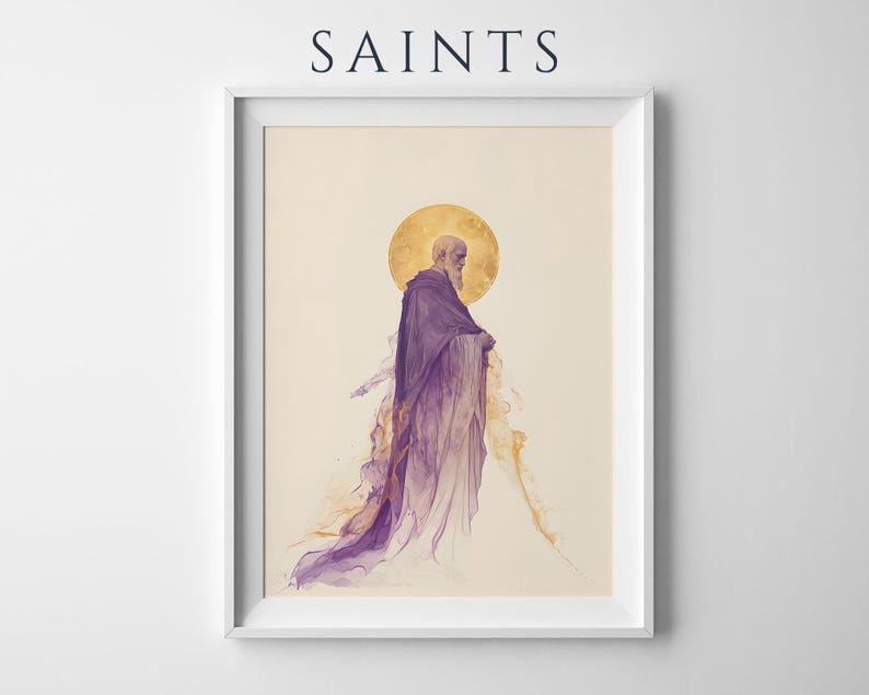 May include: A framed art print titled SAINTS featuring a bearded figure in a flowing purple robe with a golden halo behind the head. The figure is depicted in a watercolour style with ethereal, wispy edges fading into a cream-coloured background.
