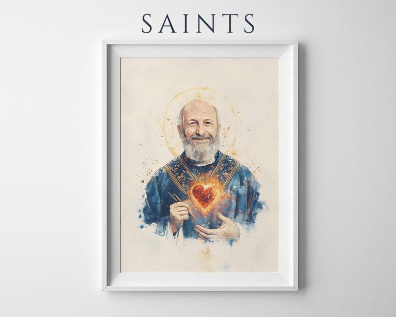 May include: A framed wall art print titled SAINTS featuring a watercolor-style portrait of a bearded person in a blue vestment with a glowing, fiery heart emblem on the chest and a golden halo, presented in a simple white rectangular frame.