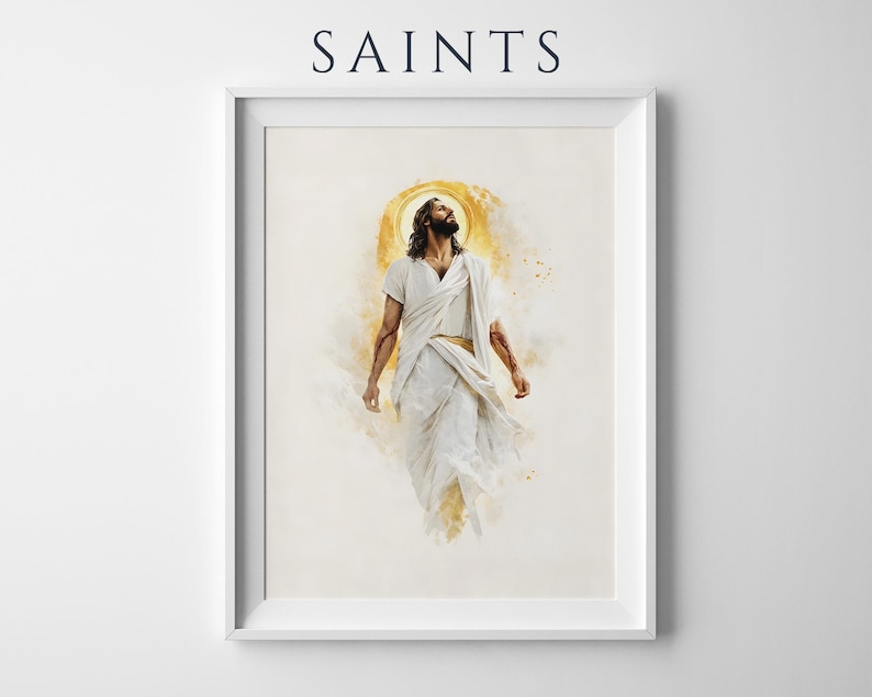 May include: A framed wall art print featuring the word SAINTS at the top. The artwork depicts a figure with long dark hair and a beard, wearing white robes, looking upward with a golden halo effect behind the head against a light background.