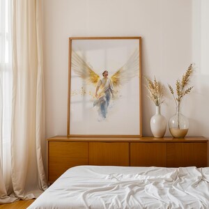 May include: A framed vertical wall art print featuring a watercolor-style illustration of a figure with large, expansive golden wings. The figure is depicted in a flowing white garment, looking upward with a sense of motion and ethereal light.
