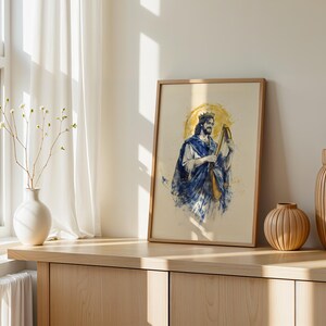 May include: A framed art print featuring a watercolour-style illustration of a bearded figure wearing a crown and blue robes while playing a harp. The artwork is set against a light background with a golden circular halo behind the figure's head.