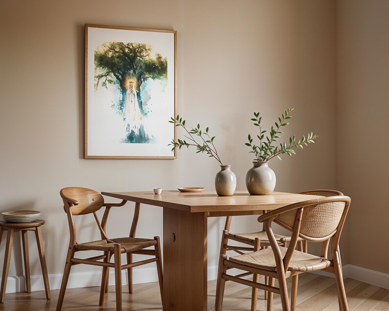 May include: A wooden dining table with four chairs featuring woven seats and curved backrests. Two ceramic vases with green branches sit on the table. A framed watercolour print of a figure standing before a large tree hangs on the wall.