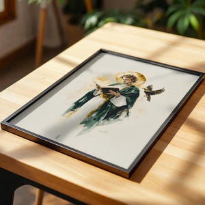 Pu&ograve; includere: Una stampa artistica incorniciata con un'illustrazione in stile acquerello di una figura in tunica verde scuro con un'aureola dorata, intenta a leggere un libro aperto. Un uccello scuro &egrave; raffigurato in volo accanto alla figura su sfondo bianco.