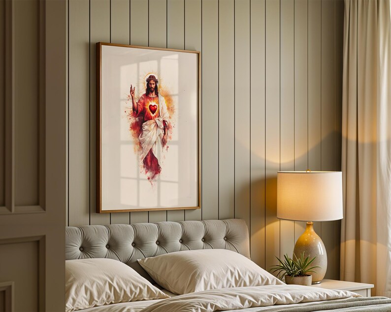 Puede incluir: Una impresi&oacute;n de arte mural enmarcada que presenta una ilustraci&oacute;n estilo acuarela de una figura con cabello largo casta&ntilde;o, una corona de espinas y un coraz&oacute;n rojo brillante en el pecho, vistiendo t&uacute;nicas blancas y rojas, con una mano alzada.