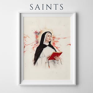 K&ouml;nnte beinhalten: Ein gerahmter Kunstdruck mit dem Titel SAINTS, der eine Nonne in schwarz-wei&szlig;em Habit mit einem roten Buch zeigt. Hinter der Figur befindet sich ein aquarellartiger Ausbruch aus rotem und orangefarbenem Licht. Der Rahmen ist schlicht und wei&szlig;.
