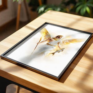 May include: A framed print featuring an illustration of a winged figure with golden wings, wearing a white robe and a gold collar, holding a glowing staff in one hand and a fish in the other, set against a bright, ethereal white background.