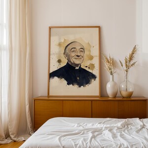 May include: A framed portrait print featuring a watercolor-style illustration of an elderly man wearing a black clerical shirt with a white collar. The artwork uses shades of black, white, and gold, with ink splatters surrounding the subject.