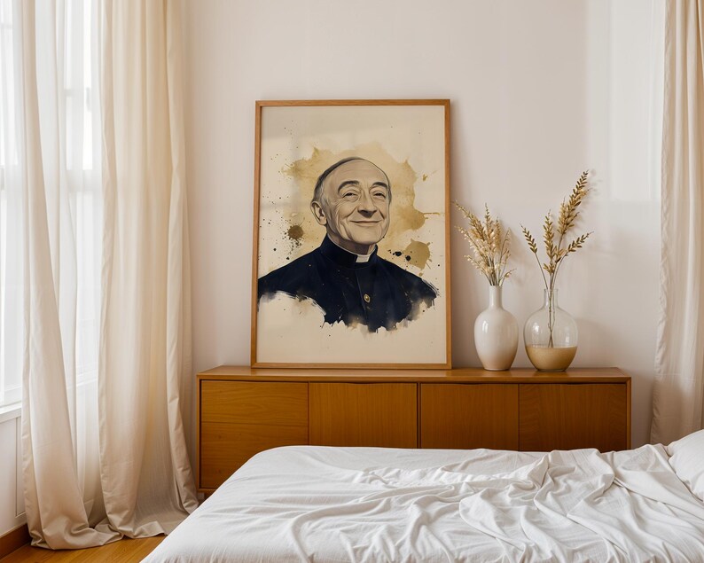 May include: A framed portrait print featuring a watercolor-style illustration of an elderly man wearing a black clerical shirt with a white collar. The artwork uses shades of black, white, and gold, with ink splatters surrounding the subject.
