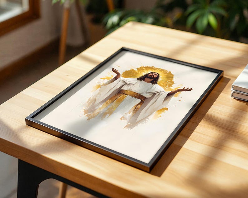 May include: A framed print featuring a central figure with long dark hair and a beard, wearing white robes with a gold sash, arms outstretched, surrounded by a golden halo effect, rendered in a watercolour style on a light background.