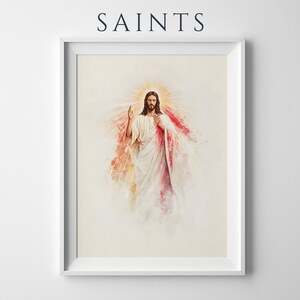 May include: A framed wall art print featuring the word SAINTS at the top. The artwork depicts a figure with long brown hair and a beard, wearing white robes, with red and gold watercolor-style light rays emanating from behind the figure.