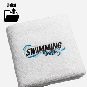 May include: A white terry cloth towel featuring an embroidered design with the word SWIMMING in black capital letters, accompanied by light blue and dark blue wave graphics and a pair of blue swimming goggles positioned below the text.