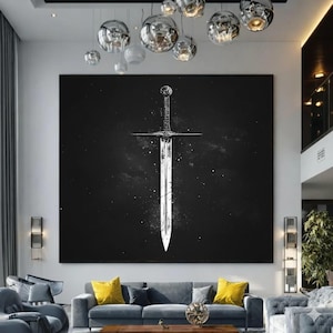May include: A large square wall art piece featuring a white, weathered sword illustration centred on a solid black background. The sword has a detailed hilt, a straight crossguard, and a pointed blade with visible distressed texture and white speckles.