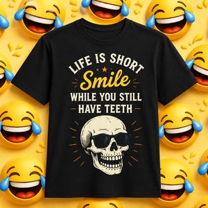 May include: Black t-shirt with the text "LIFE IS SHORT Smile WHILE YOU STILL HAVE TEETH" and a skull wearing sunglasses. The background is yellow with laughing emoji faces.