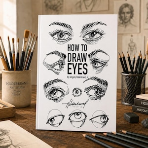 Op de afbeelding: Een wit boek met de titel "HOW TO DRAW EYES" met gedetailleerde oogillustraties. Het boek ligt op een houten bureau met kunstbenodigdheden, waaronder potloden, penselen en een houten kunstenaarsfiguur. Door Gregory Hilderbrand, Jr.