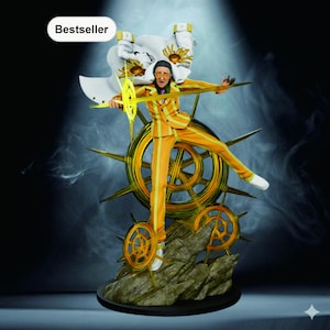 May include: A figurine of a character in an orange and yellow striped suit, white cape, and sunglasses, holding a golden weapon. The figure is posed in front of a golden wheel-like structure and a rocky base. The word "Bestseller" is in the top left corner.