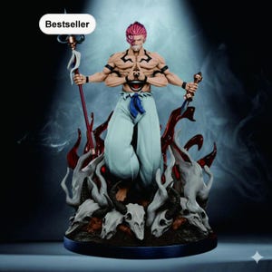 May include: A detailed figurine of a character with pink hair, multiple arms, and a distinctive facial design. The figure is dressed in light blue pants and stands atop a base with skulls and red flame accents. The word "Bestseller" is in the top left corner.