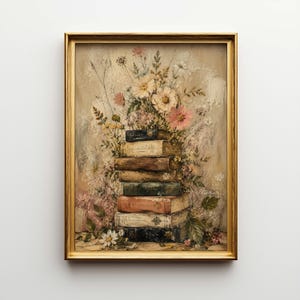 May include: A framed artwork featuring a stack of vintage books adorned with a floral arrangement. The books are in various colors, and the flowers include pink, white, and yellow blooms. The frame is gold.