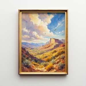 May include: A framed landscape painting depicts a desert canyon scene. The artwork features a golden frame, a blue sky with fluffy clouds, and a soaring bird. The foreground shows desert vegetation and a valley.