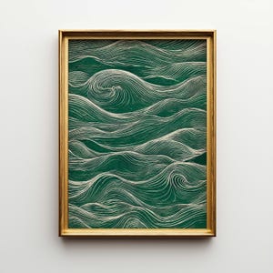 May include: A framed artwork featuring a green and white wave pattern. The artwork is encased in a gold-colored frame. The wave design is composed of white, flowing lines against a dark green background, creating a sense of movement and depth.