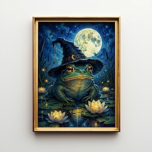 May include: Framed art print depicting a frog in a witch's hat, set in a moonlit pond with water lilies. The frog is green with large eyes. The background is a dark blue night sky with a full moon and stars.