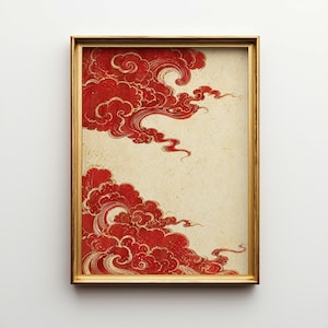 May include: Framed artwork featuring a traditional Asian-inspired design. The print showcases stylized red clouds with gold accents against a cream-colored background. The artwork is enclosed in a gold-colored frame.
