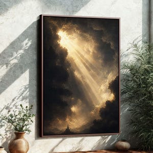 May include: A framed artwork depicting a dramatic sky scene. The image features dark, ominous clouds with a brilliant golden light breaking through, creating a striking contrast. A small silhouette of a building is visible at the bottom.