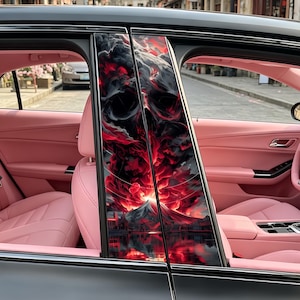 May include: Car door pillar wraps featuring a striking red and black skull and landscape design. The car's interior has pink leather seats and trim. The image shows a street scene visible through the car window.