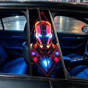 May include: Car window decals displaying a colourful Iron Man helmet illustration. The design uses red, orange, and blue tones, set against a black backdrop. The decals are fitted on a black car, with blue interior lighting visible.