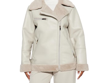 May include: An off-white faux leather jacket featuring a wide, plush beige faux fur collar and matching fur trim at the cuffs and hem. The jacket includes a diagonal silver-tone zipper closure, two zippered side pockets, and one zippered chest pocket.