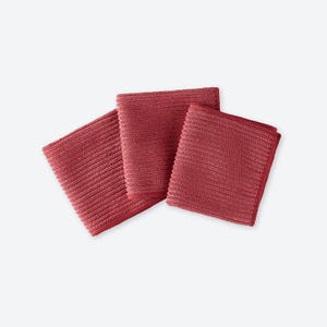 May include: Three red square microfiber cloths are arranged on a white background. The cloths have a ribbed texture and are folded neatly. The color is a deep, rich red, and the cloths appear soft and absorbent.