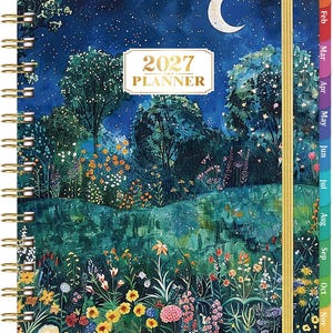 May include: A 2027 planner with a spiral binding and a gold elastic closure. The cover features a night scene with a crescent moon, a starry sky, and a lush garden filled with colorful flowers and trees. Monthly tabs are visible on the right side.