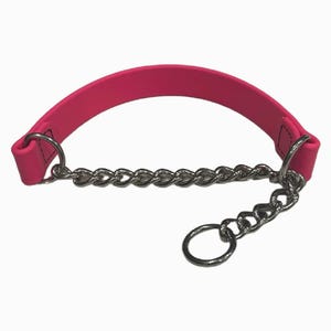 May include: A hot pink dog collar with a silver chain. The collar is made of a flexible, curved material with a chain that connects to a ring. The chain is made of silver metal.
