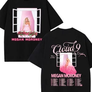 May include: Black t-shirt featuring a graphic of a woman in a pink dress framed by a window, with the text "MEGAN MORONEY" below. The back of the shirt has the text "Cloud 9 Tour" and the artist's name.
