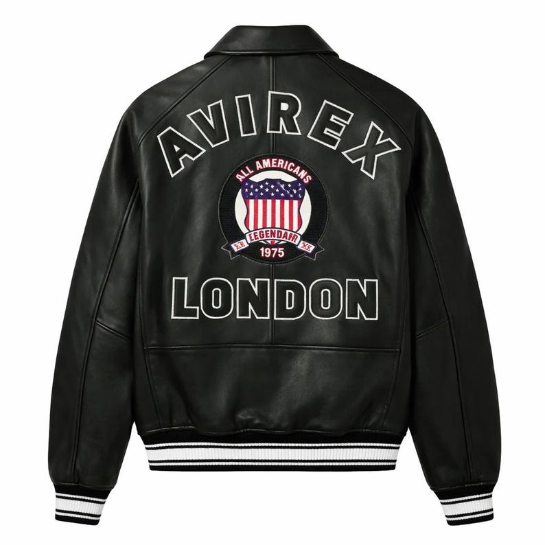 May include: Black leather jacket with white lettering and a patch featuring a shield and the text "ALL AMERICANS 1975 LONDON". The jacket has a collar, ribbed cuffs, and a striped hem.