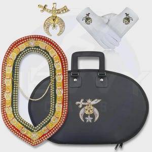 May include: A set of ceremonial regalia including a gold-tone metal pendant with a crescent and scimitar, a pair of white gloves with embroidered emblems, a red, yellow, and green beaded collar, and a black oval carrying case with a matching emblem.