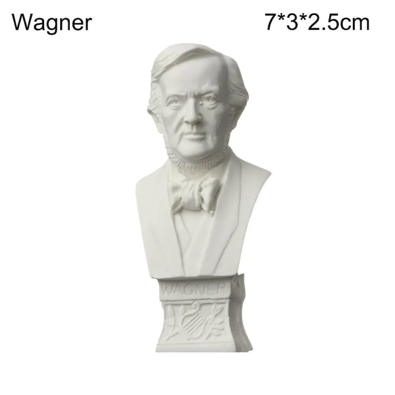 May include: A white bust of Wagner, 7 x 3 x 2.5 cm. The sculpture features a detailed depiction of a man's head and shoulders, with a bow tie and a suit. The base of the bust is inscribed with the name "Wagner".