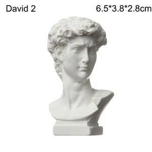May include: A white bust of David, a classical sculpture. The bust is 6.5cm tall, 3.8cm wide, and 2.8cm deep. The sculpture features detailed facial features and curly hair. The text "David 2" is above the bust.