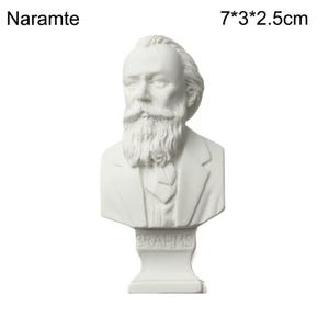 May include: A white bust of a man with a long beard and a suit. The bust is labeled "BRAHMS" at the base and measures 7*3*2.5cm. The word "Naramte" is printed at the top left.