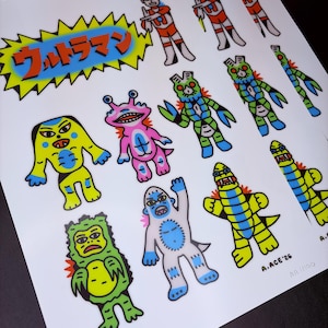 May include: A print featuring colorful cartoon illustrations of various characters, including robots and monsters. The Japanese text "Ultraman" is displayed in a yellow and blue burst. The artwork includes the text "A.ACE '26" and "AA 1/50".
