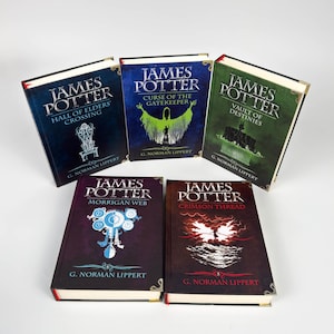 May include: A collection of five hardcover books titled James Potter by G. Norman Lippert. The titles include Hall of Elders Crossing, Curse of the Gatekeeper, Vault of Destinies, Morrigan Web, and Crimson Thread, each featuring unique cover art.