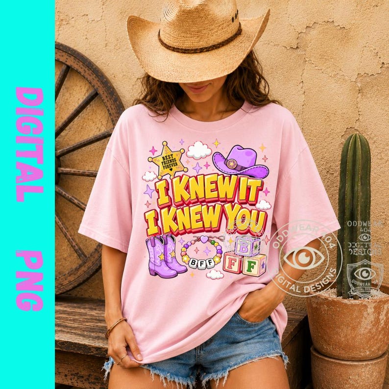 May include: A light pink t-shirt featuring a graphic print with the text I KNEW IT I KNEW YOU. The design includes a yellow sheriff star, a purple cowboy hat, purple boots, a beaded bracelet with BFF, and alphabet blocks labeled B, F, and F.
