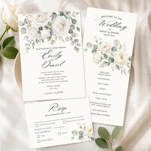May include: A wedding stationery set featuring a white invitation, program, and RSVP card with floral illustrations of white roses and sage green eucalyptus leaves. The text includes names Emily and Daniel, wedding details, and event timelines.