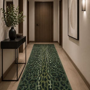 May include: A long, rectangular runner rug featuring a deep green and black leopard print pattern. The rug has a textured, pile surface that covers the floor of the hallway, displaying a repeating animal spot design in varying shades of dark green.