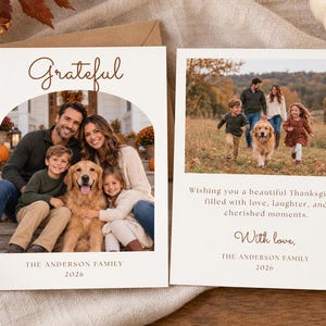 May include: Two white rectangular holiday cards featuring family photographs. The left card has an arched photo of a family and dog with the text Grateful and The Anderson Family 2026. The right card shows a family walking in a field with text.